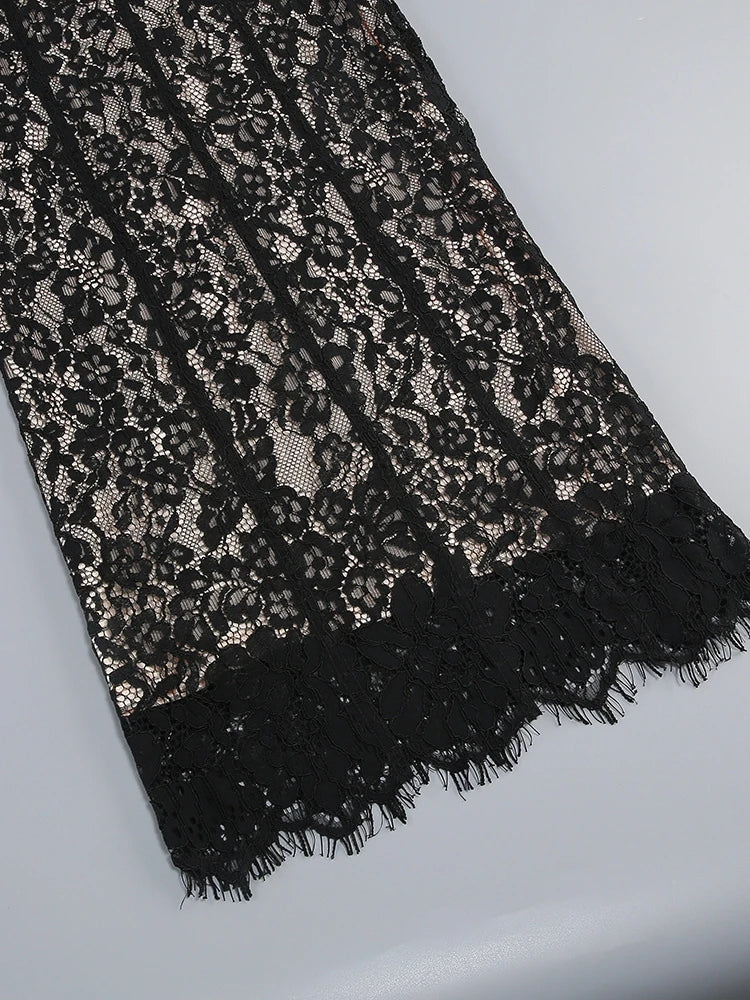 Black lace fabric on a light gray background