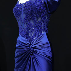 Blue evening gown with intricate beading on a black background