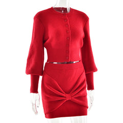 Red knit dress with a bow detail on a white background