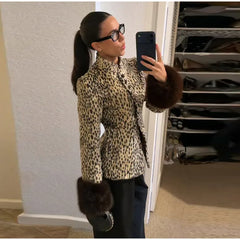 Spotted faux fur jacket with a stand collar.