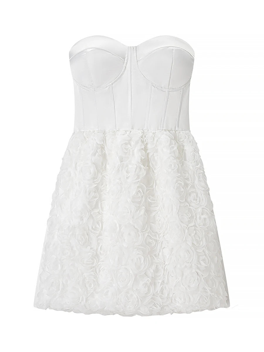 White strapless dress with floral lace details on a white background