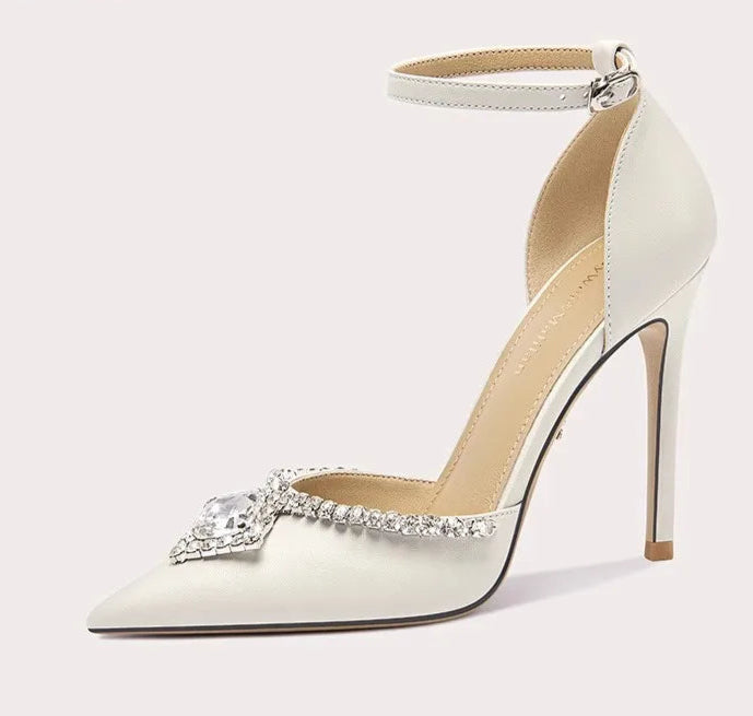 White high-heeled shoe with decorative element on a white background
