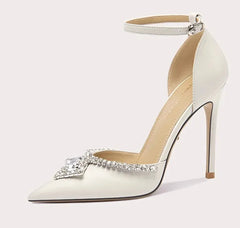 White high-heeled shoe with decorative element on a white background
