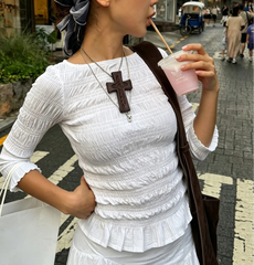 Smocked 3/4 sleeve peplum top in white.