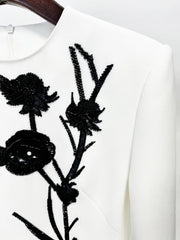 Close-up of floral beadwork on mini dress