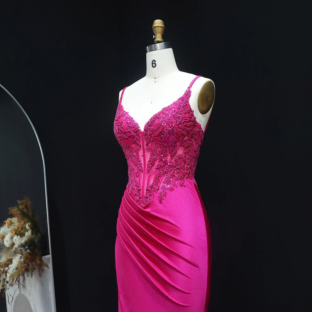 Pink evening gown on a mannequin against a black background