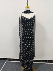Black dress with white polka dots on a mannequin against a white background