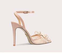 Beige high-heeled shoe with bow detail on a light gray background