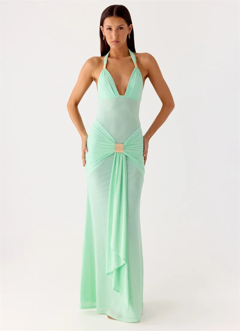 Woman wearing a mint green evening gown on a white background