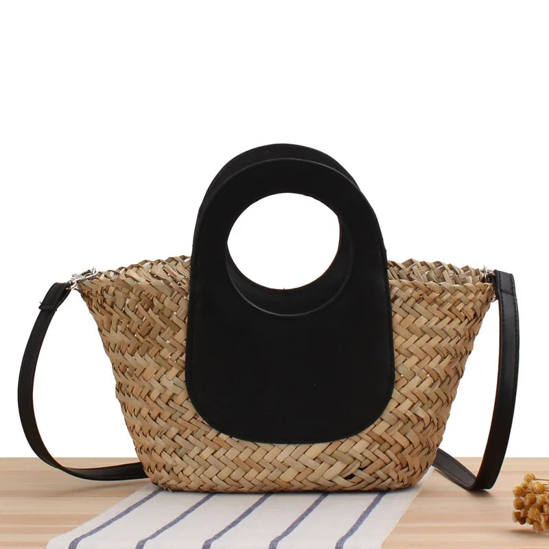 Woven handbag with black circular handle on a wooden surface