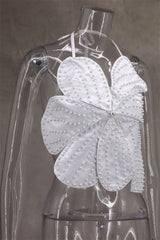 White butterfly-shaped garment on a transparent mannequin against a neutral background