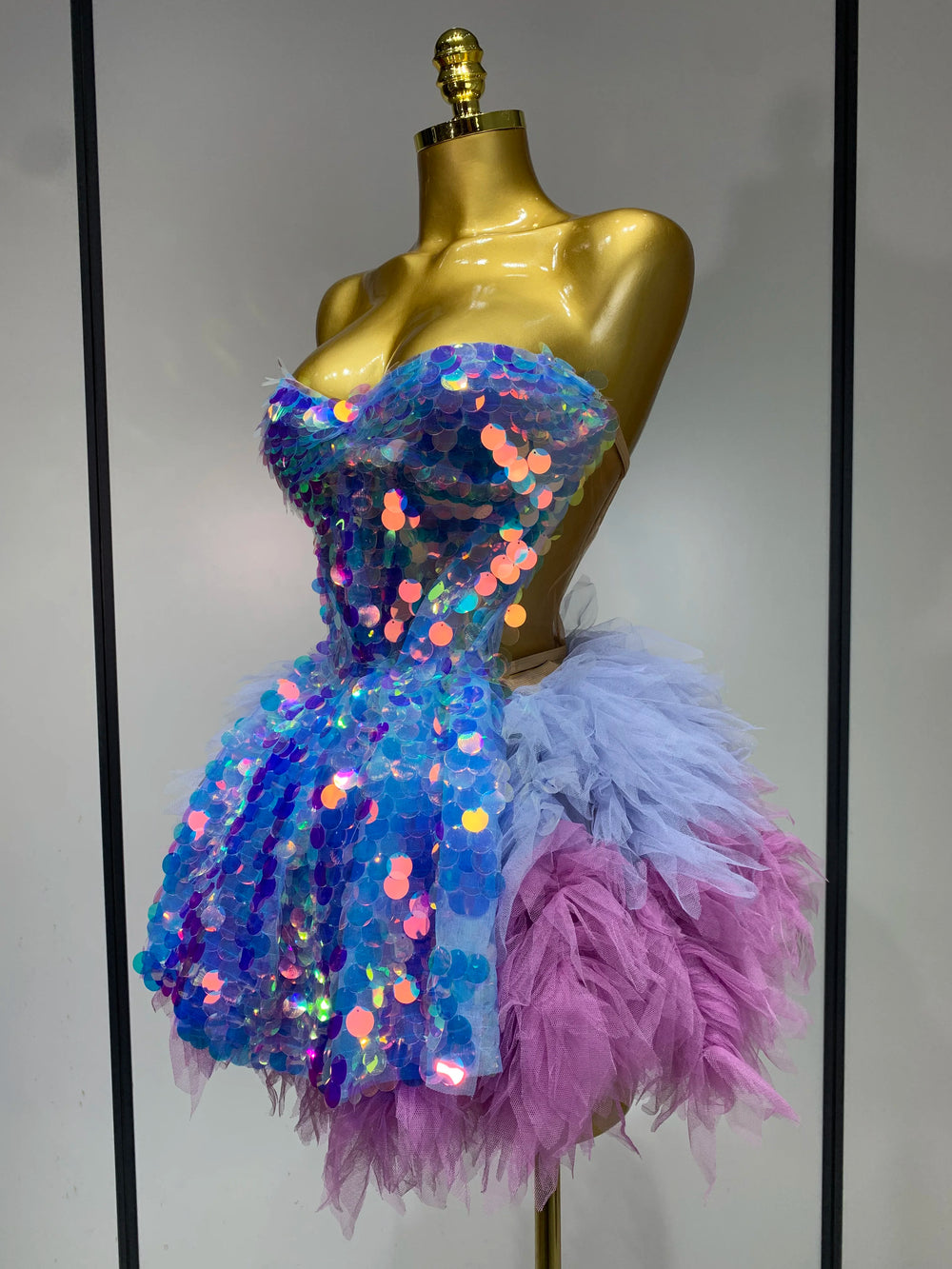 Iridescent blue and pink strapless sequin and feather mini dress side view