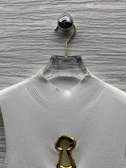 White sweater on a hanger against a textured gray background