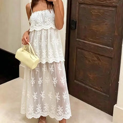 Close-up of floral lace detail on a sheer mesh midi dress