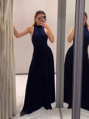 Woman wearing a black evening gown taking a mirror selfie.