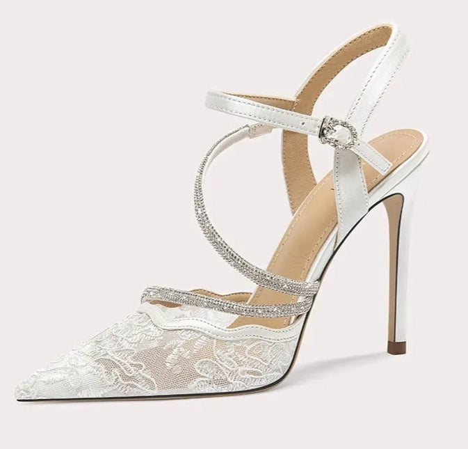 White high-heeled sandal with lace details on a white background