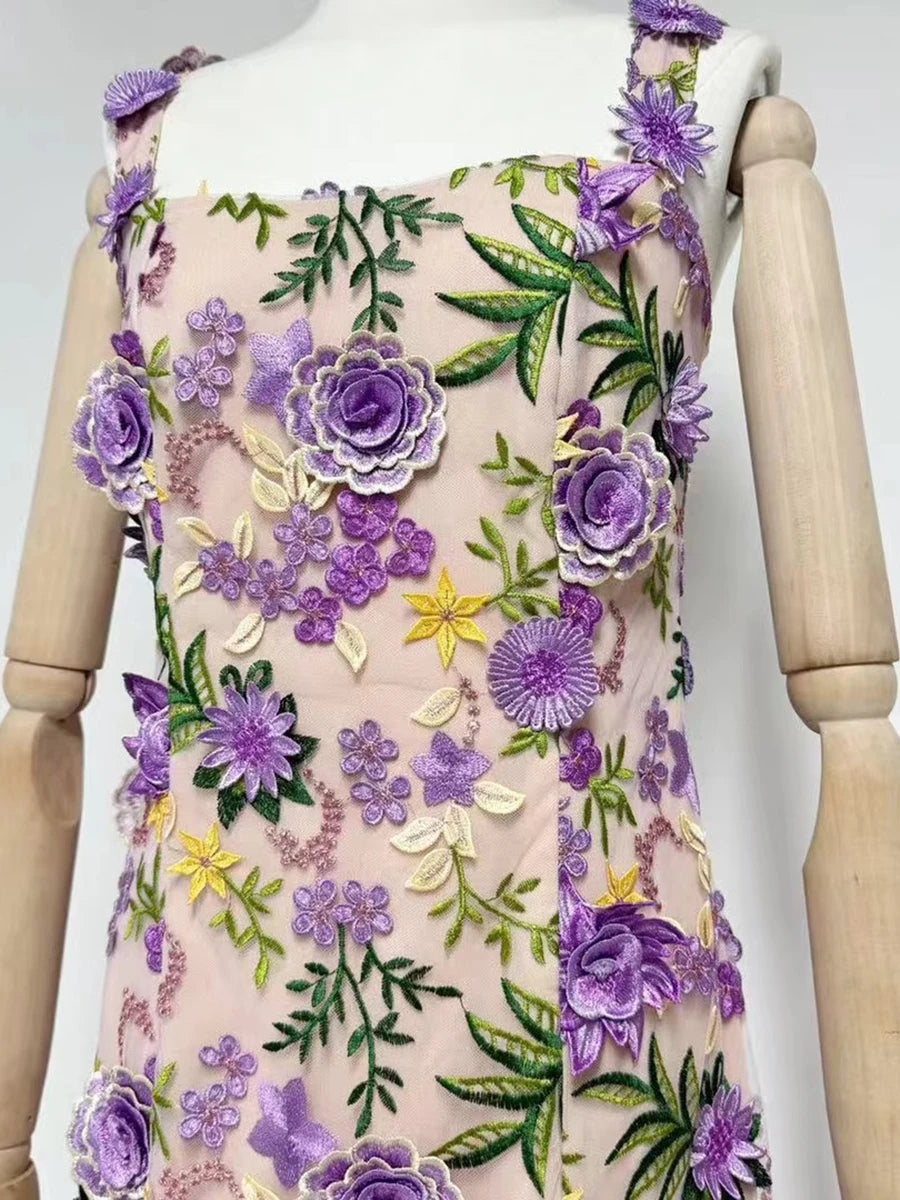 Mannequin wearing a dress with floral embroidery on a white background