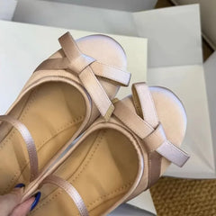 Close-up of nude pink satin mary jane ballet flats bow