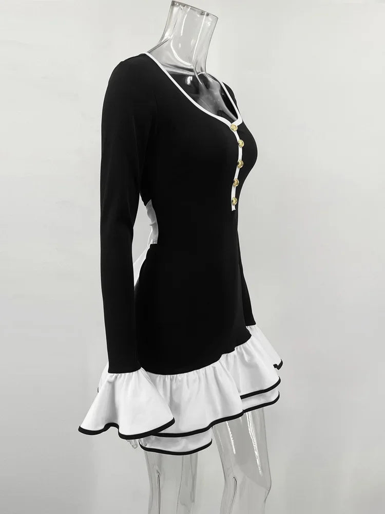 Black dress with white ruffled skirt on a mannequin against a white background
