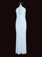 Light blue halter neck dress with floral details on a white background