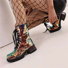 Multicolored sequin boots worn with fishnet stockings on a light background