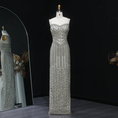 Silver beaded evening gown on a mannequin against a black background