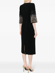 Back view of black midi dress with embellished sleeves and a subtle slit