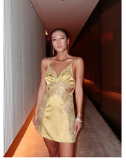 Woman wearing a yellow lace dress in an indoor setting