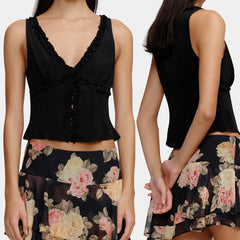 Black top and floral skirt set on a plain background