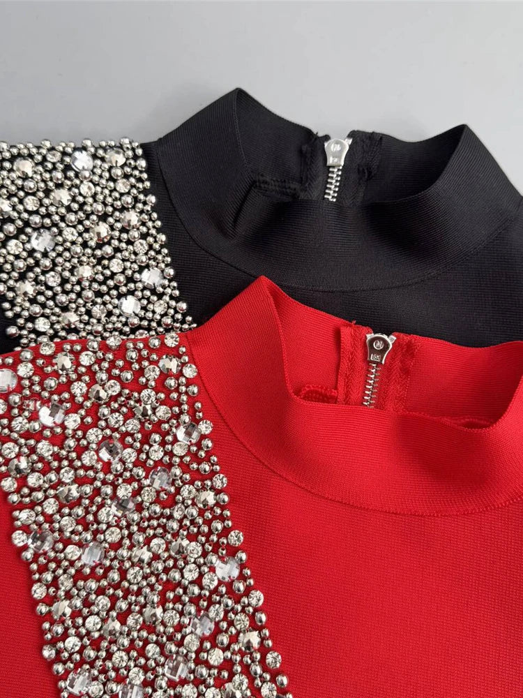 Close-up of a black and red top with silver embellishments on a gray background
