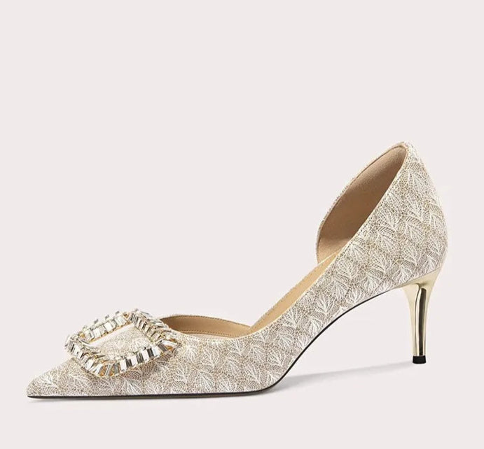 High-heeled shoe with decorative bow on a white background