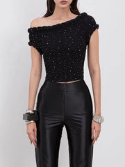 Black off-shoulder top with sequins and black pants