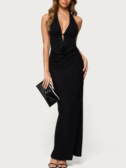 Black halter neck dress worn by a model on a white background