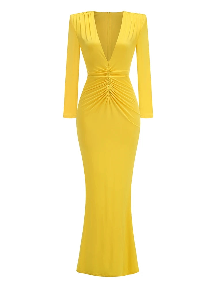 Yellow evening gown with long sleeves on a white background