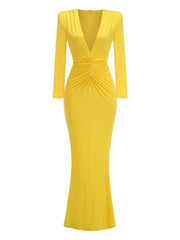 Yellow evening gown with long sleeves on a white background