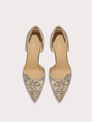 Pair of embellished high-heeled shoes on a light beige background