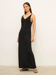 Woman wearing a black sleeveless dress against a white background