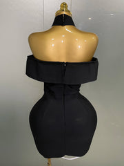 Black dress on a mannequin against a plain background