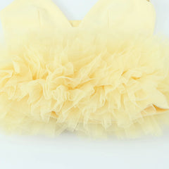 Close-up of light yellow tulle fabric on a white background