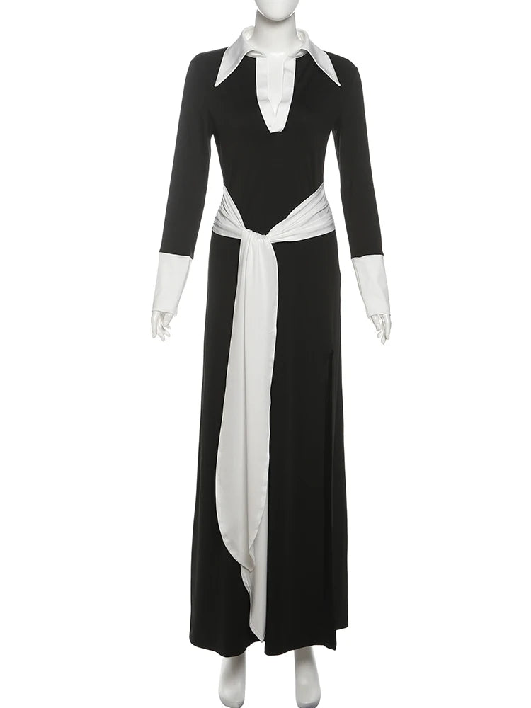 Black dress with white accents on a mannequin against a white background