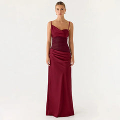 Woman wearing a burgundy one-shoulder gown on a white background