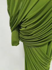 Green pleated fabric on a white background