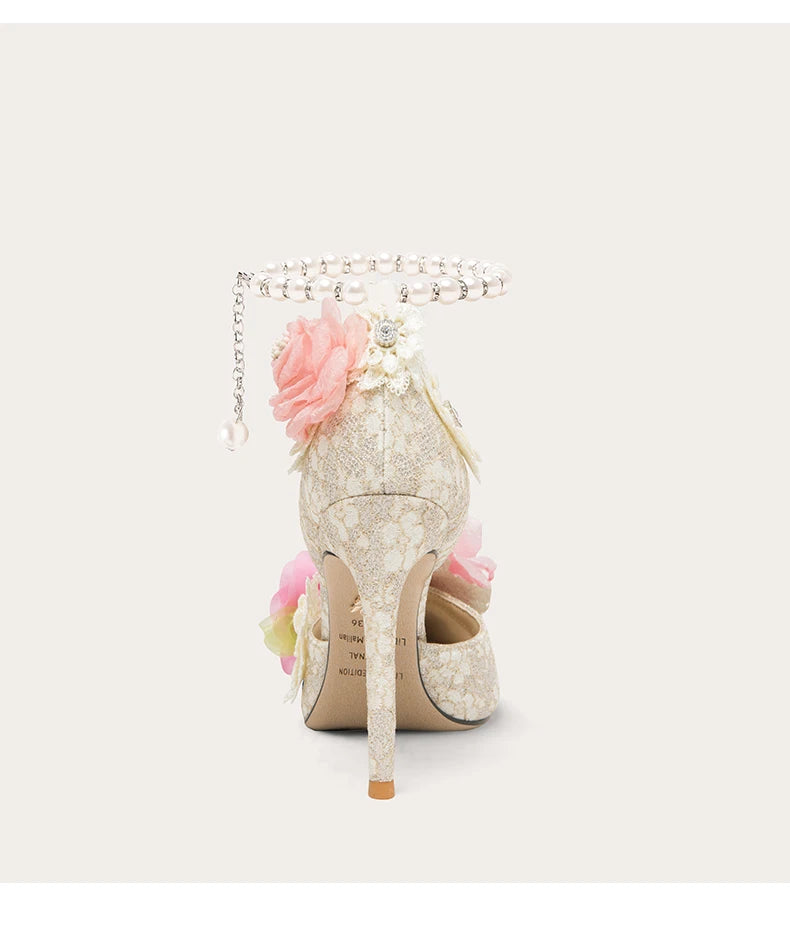 Decorative high-heeled shoe with floral elements on a white background