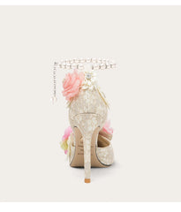 Decorative high-heeled shoe with floral elements on a white background