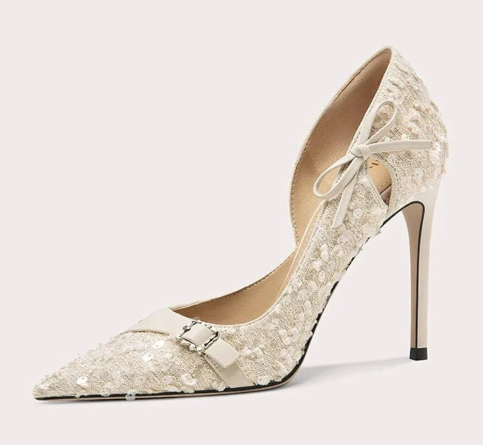 High-heeled shoe with lace design on a light gray background