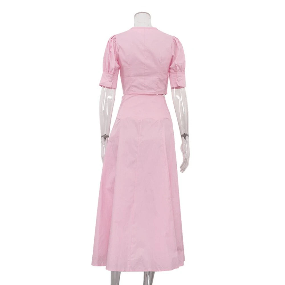 Pink dress on a mannequin against a white background