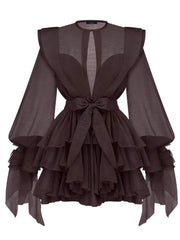 Dark brown dress with ruffled layers and sheer sleeves on a white background