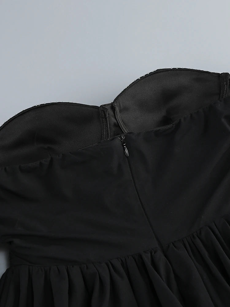 Black strapless dress on a light gray background