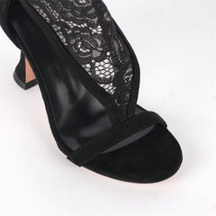 Close-up of the toe and strap detail on black lace over the knee boots.