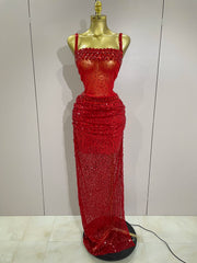 Red beaded evening gown on a mannequin against a plain background